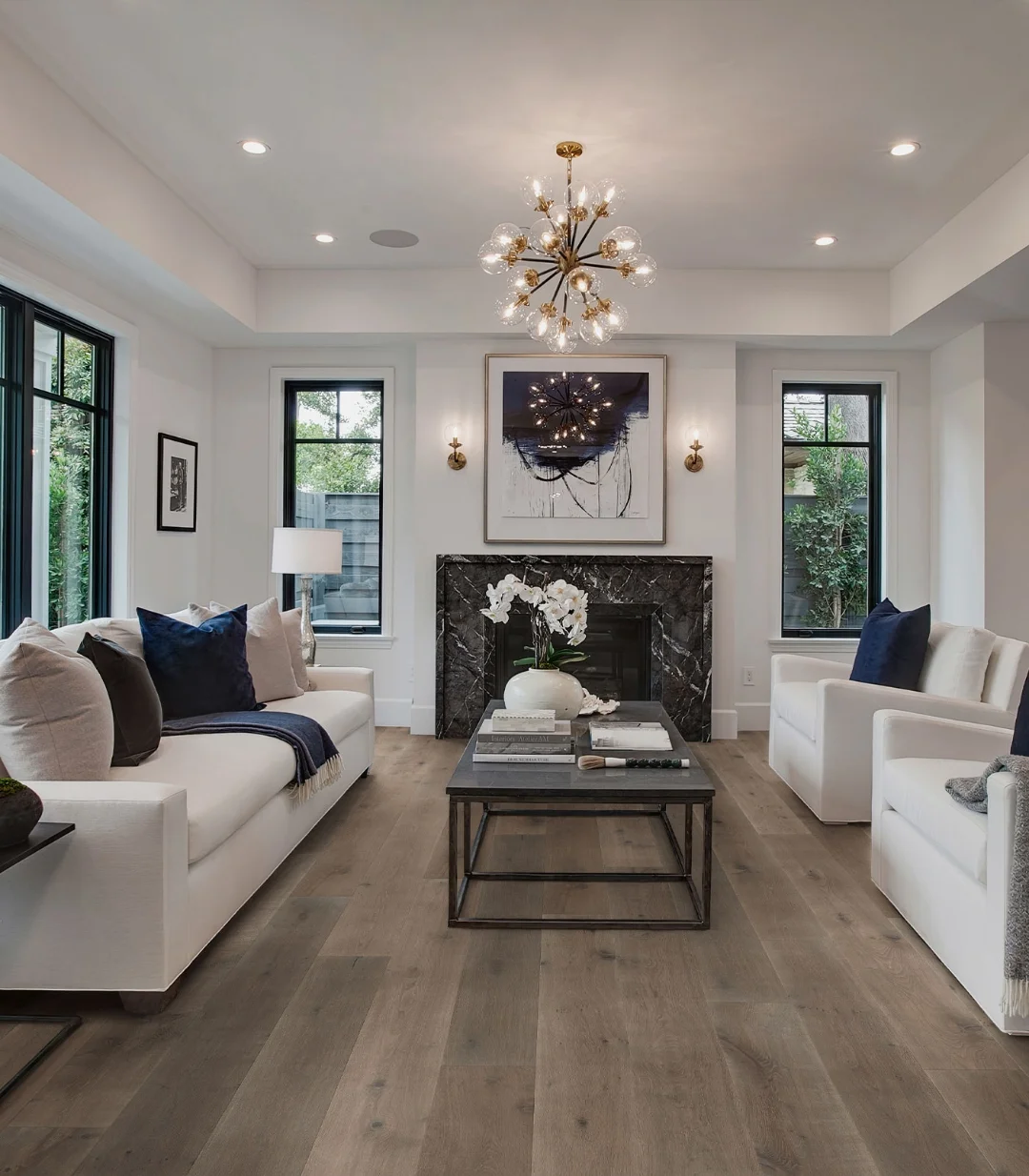 Living room showcasing natural-grade wide-plank hardwood flooring with warm tonal variation and contemporary interior styling
