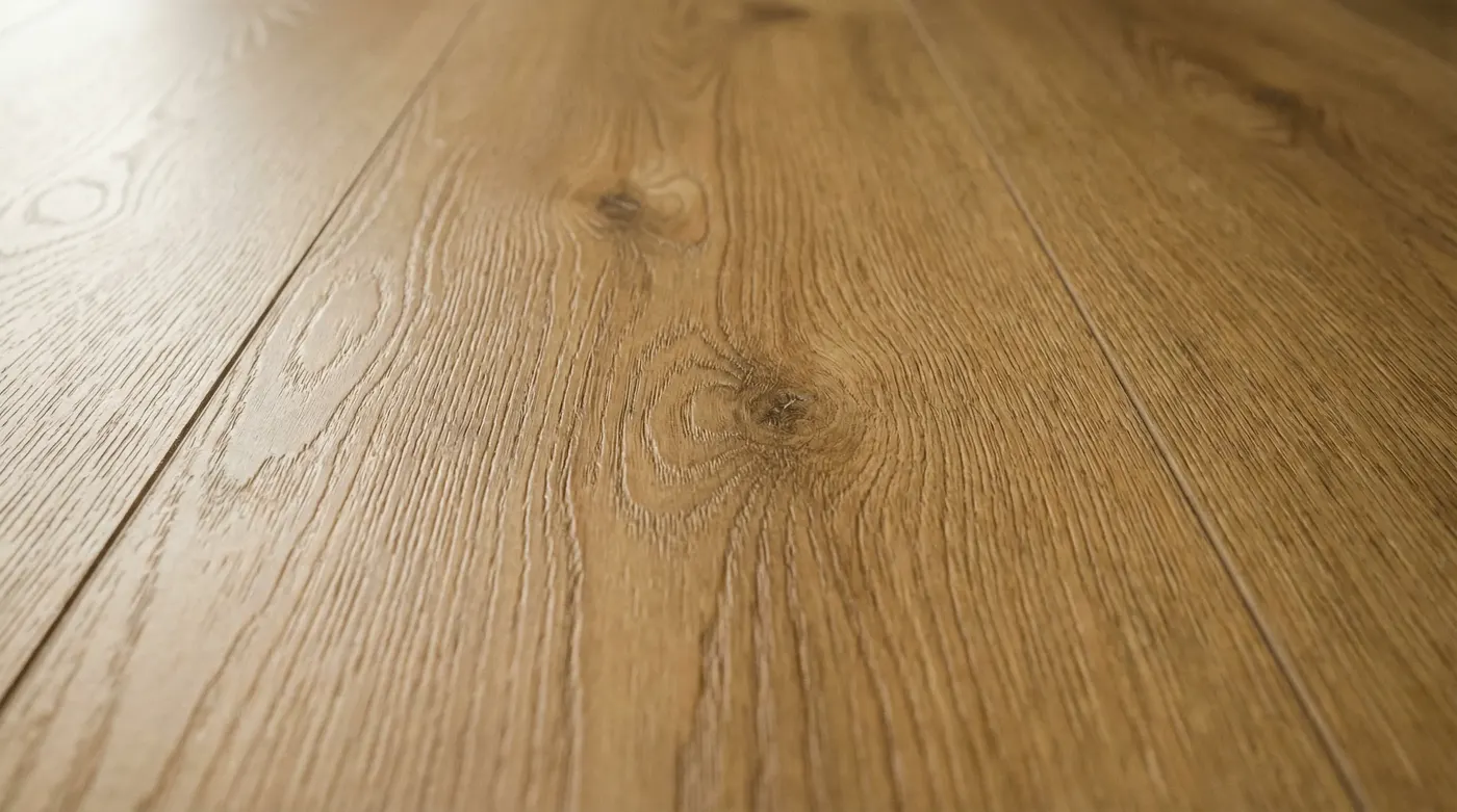 Close-up of a matte-finish hybrid plank floor showing realistic wood grain texture — product beauty shot, warm tones